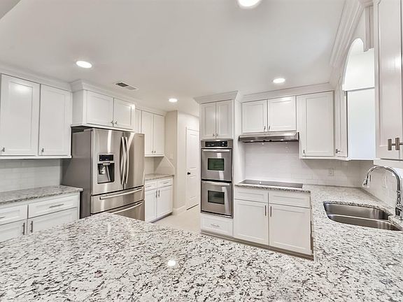 The kitchen looks like it was straight out of a Better Homes & Gardens magazine! The fur down was removed and new custom built upper 42 inch cabinets installed. New doors on the bottom cabinets with the exception of the island. The island was custom 
