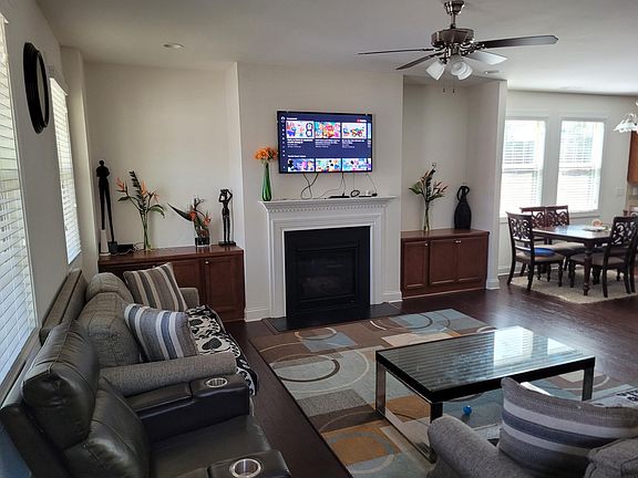 Living room with with break nook, fireplace, built in cabinets, prewired ceiling fan