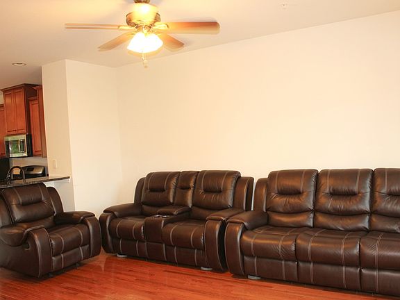 Living area with hardwood and recessed lights and natural light