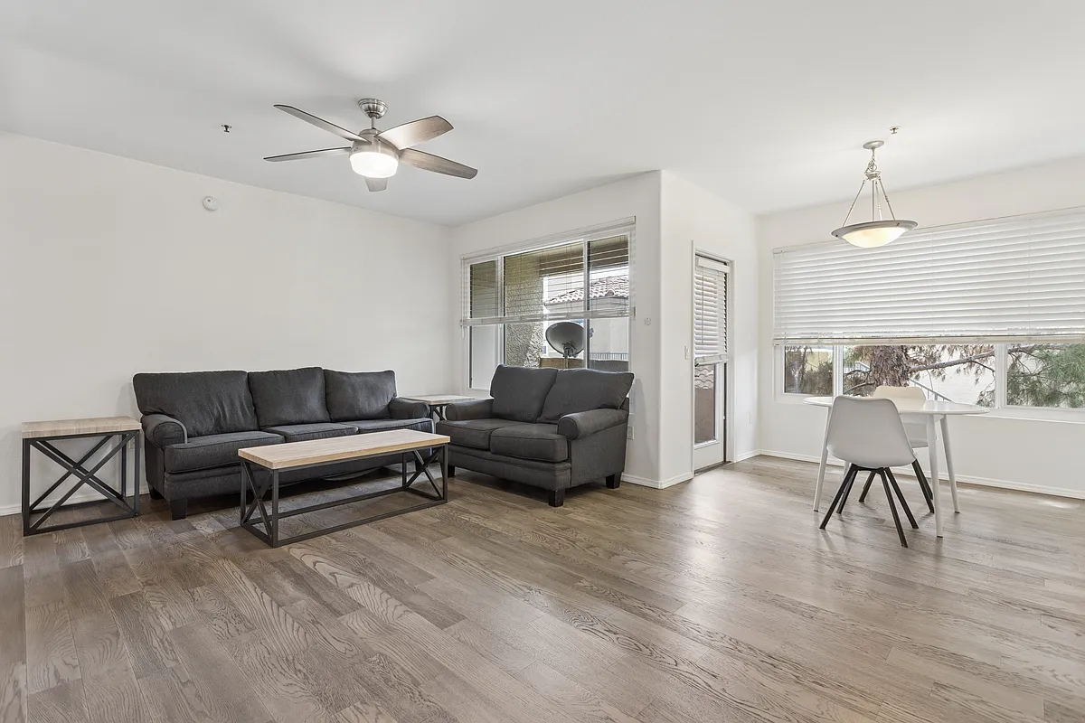 Photo 1 of 32 - 4925 E Desert Cove Ave #358 - Scottsdale, AZ Large great room with new fan, new wood flooring, new windows, like new blinds, sofa and love seat and small table and chairs - 4925 E Desert Cove Ave #358
