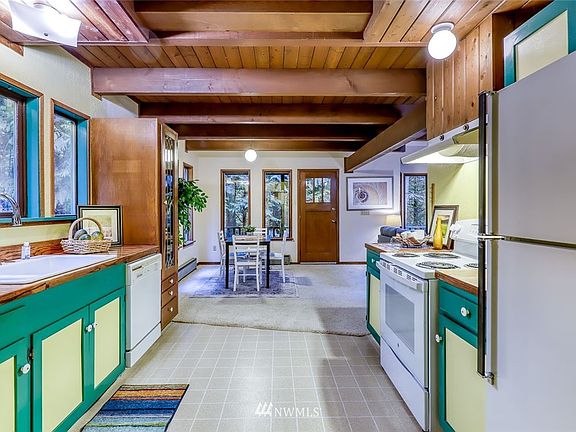 Entry on the garage side on the home, wood trimmed ceiling gives cozy, cabin style feeling.