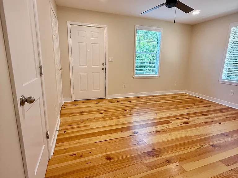 Bedroom #1 with ensuite bathroom. The door leads to the spacious back yard.