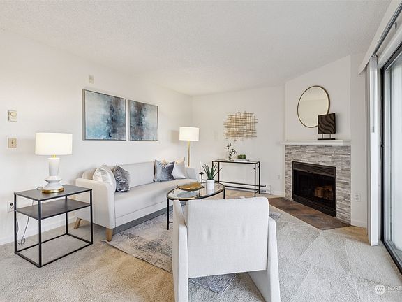 Beautifully updated with stone brick fireplace and oversized slider to view deck.>