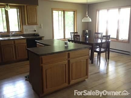 Open-concept kitchen/dining/living room.