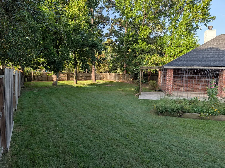 Plenty of green space for play, pets, or future outdoor projects, fully enclosed by private wood fencing.