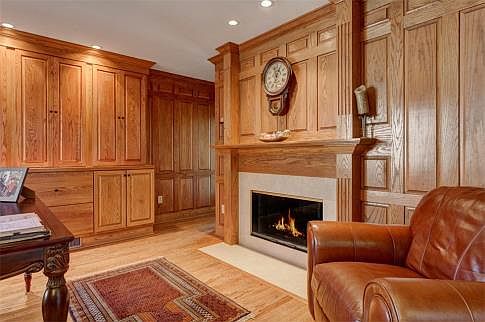 Oak-paneled study with gas log fireplace