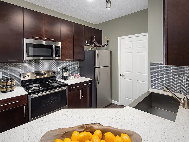 Stunning kitchens include quartz countertops and custom-patterned tile backsplash.