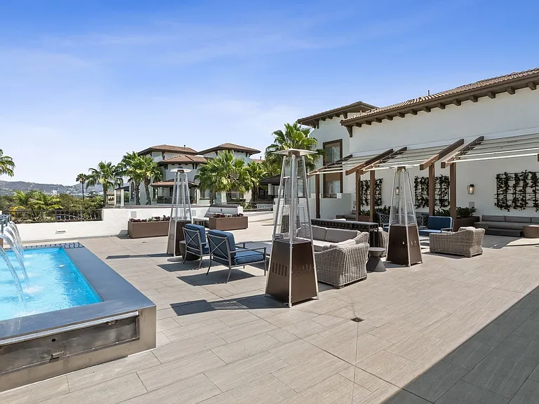 Rooftop deck exclusive to Penthouse residents features cabanas, covered fireplace lounge and bar area