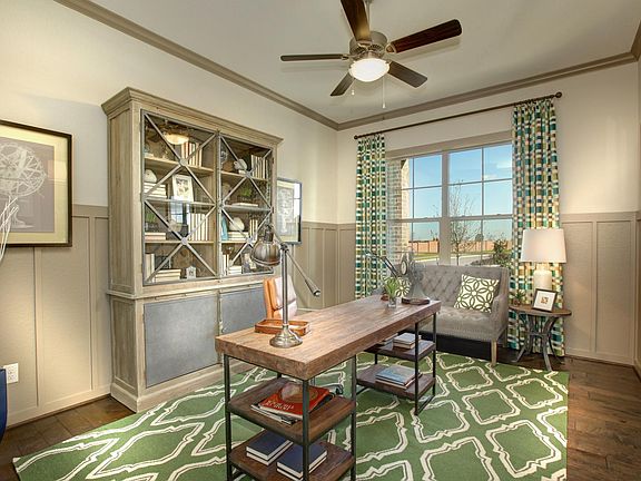 Study with ceiling fan and wainscotting