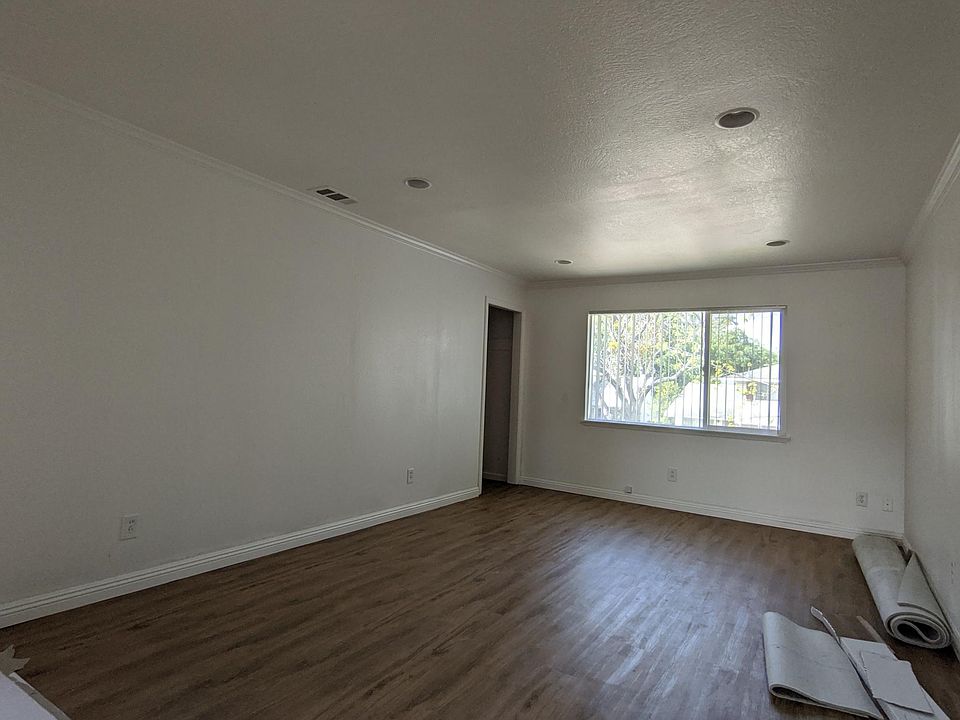 Living room, closet. Pardon the work in progress. New flooring in living room, bedrooms, and hallways. New paint throughout.