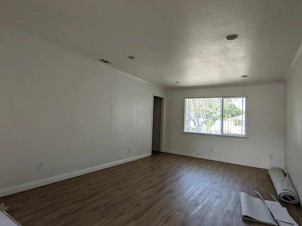 Living room, closet. Pardon the work in progress. New flooring in living room, bedrooms, and hallways. New paint throughout.