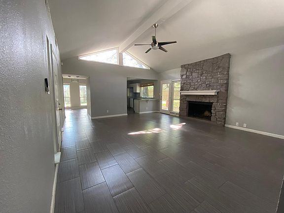 Main living room with clerestory window, vaulted ceiling and fireplace. The kitchen is to the right, the dining room left and the greatroom/office is far left, (not pictured here).