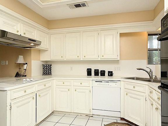 Roomy kitchen with a corner sink and view out to the front.