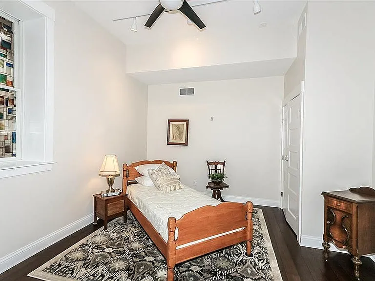 Second bedroom with hardwood floors, large closet, partially covered walk out deck with river view