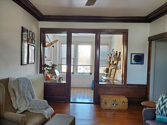View of sunroom, which perfectly doubles as an office, from the living room