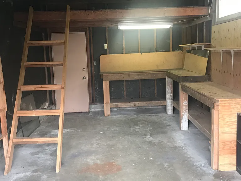 Garage with overhead storage and shelving