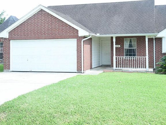 Two-car garage with four-car driveway. Electric washer/dryer connections in the garage.