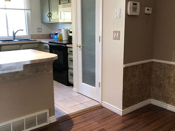Dining area looking toward Kitchen; One of two Pantries.