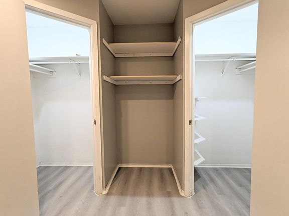 Master Bathroom Dual Walk-In Closets with Motion Sensor Lights