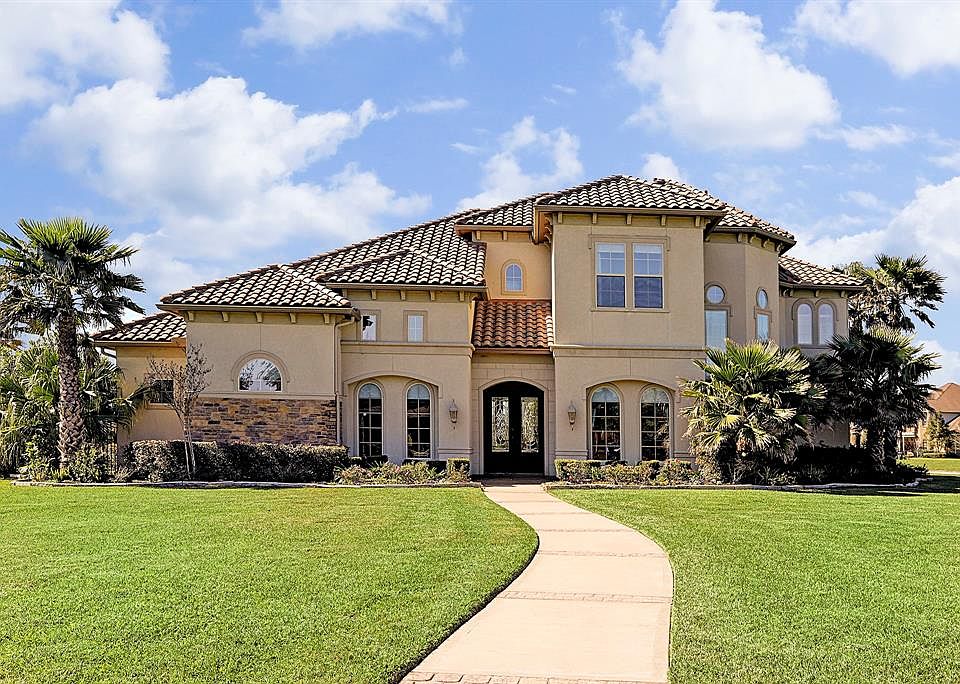 Stunning custom built home on huge corner lot with its own Guest House on a beautiful lake lot. Located in a guard gated community in a highly desirable location in Katy , which features LOW TAXES! There is no MUD=2.08 tax rate. Enjoy more home and p