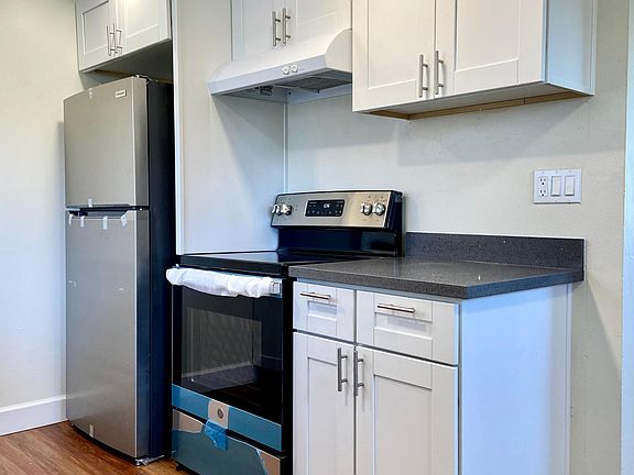 Kitchen was newly renovated with new flooring, cabinetry, counter tops, faucet fixtures, sink, garbage disposal, induction stove and oven, dishwasher, and refrigerator.