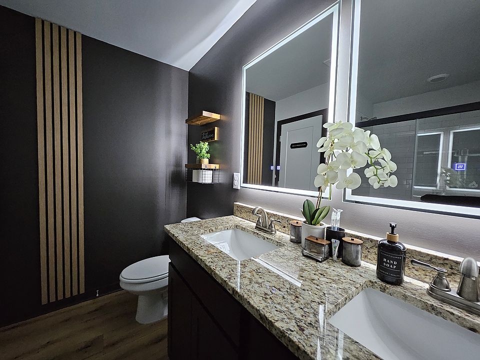 Primary Bathroom: The luxurious full bathroom nestled within the primary bedroom exudes sophistication, featuring an expansive soaking tub for ultimate relaxation. It's equipped with dual sinks for added convenience and highlights LED light-up mirrors com