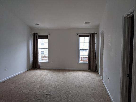 Spacious master bedroom with high ceilings.
