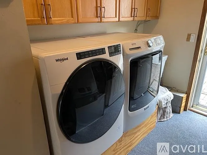Laundry Room with sink, washer/dryer, central AC/Heat and storage and back door. Security System control panel
