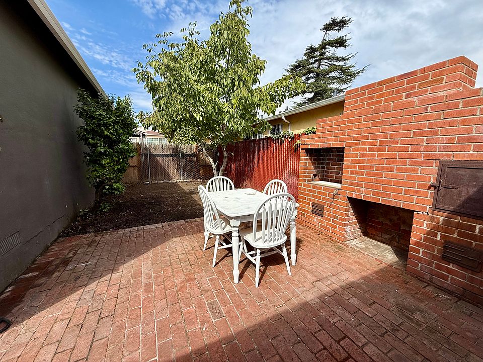 200 sq. ft. private brick patio. Perfect as an outdoor living room and dining area. Small yard beyond patio.