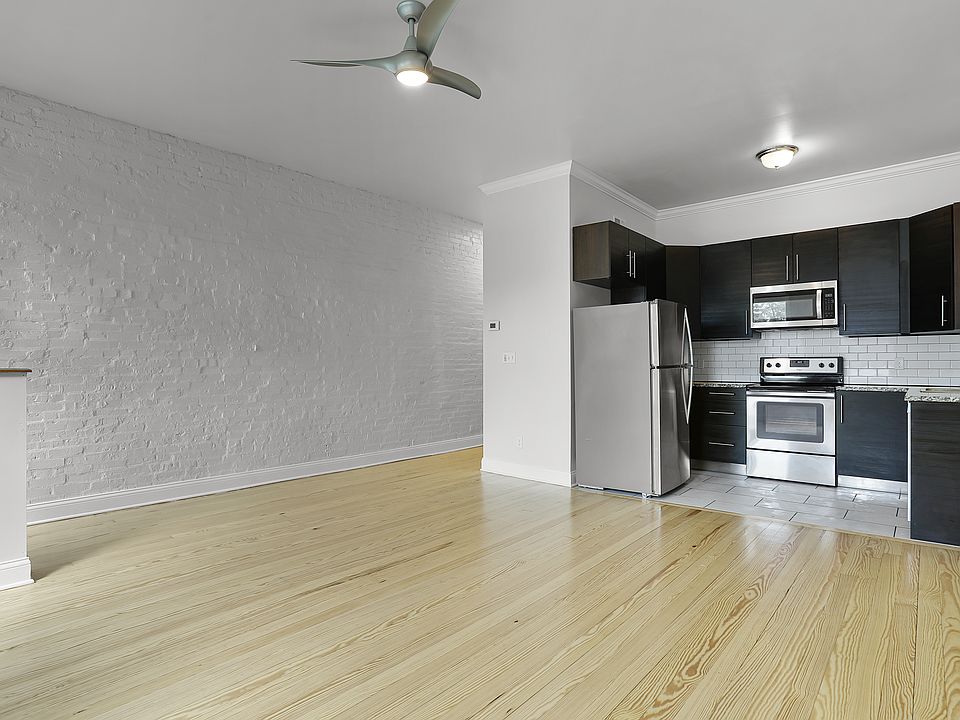 Open plan, family room looking into kitchen with granite countertops, luxury stainless steel appliance package, tiled backsplash and floor, ice maker
