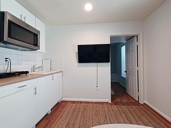 Smart tv is shown with the entrance to the bedroom next to it.