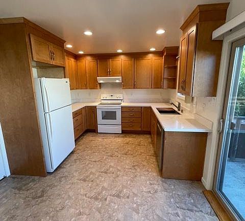 Kitchen with slider onto small balcony