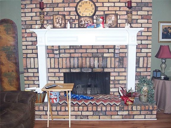 Cozy around the fireplace in the huge family room.
