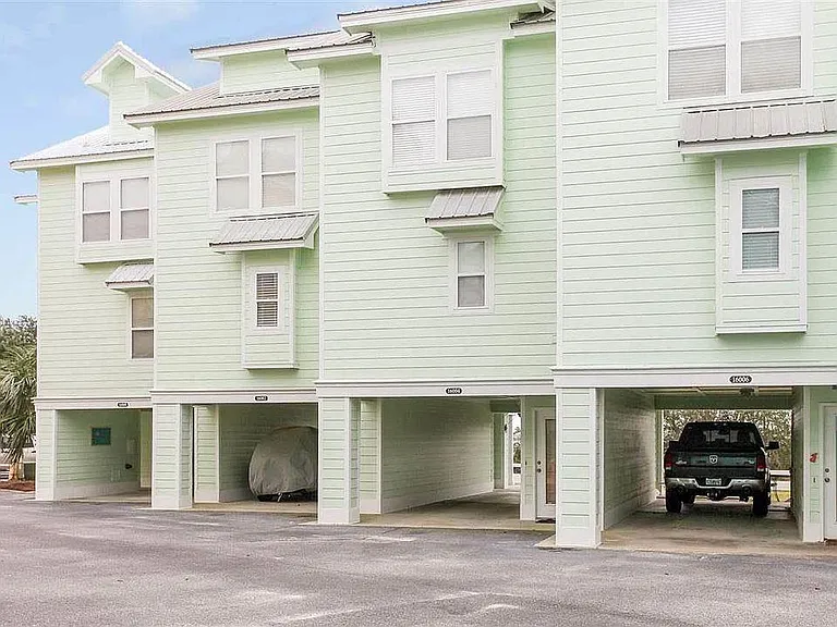 16008 is located in the mint green building , offering ample carport space for two vehicles. A dedicated storage room sits to the side providing a secure space for beach gear, bikes, kayaks or fishing equipment.