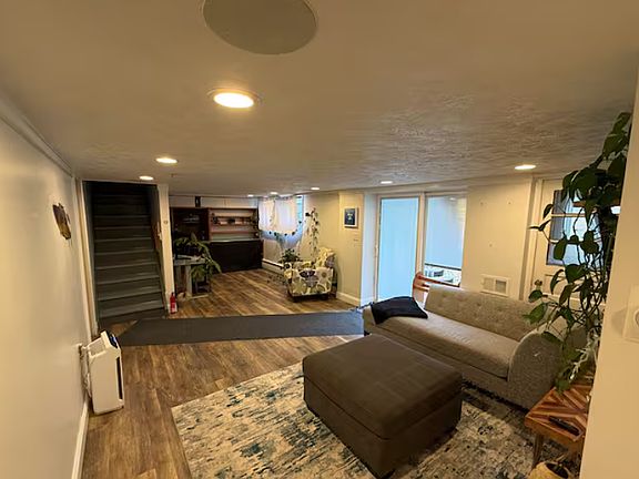 Extended lower-level layout offering multiple seating areas and flexible use of space.