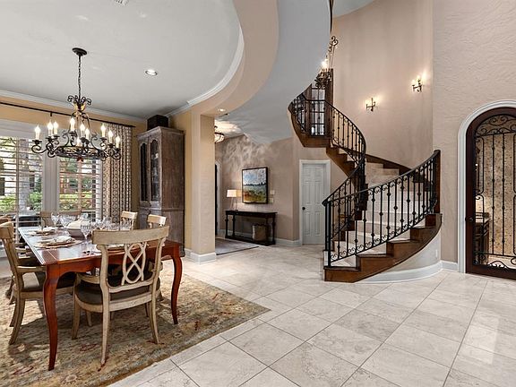 This view shows the wine grotto tucked under the stairs as well as the open formal dining room.