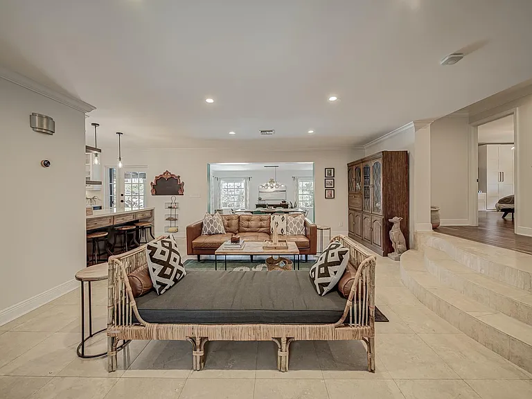 One can see the outdoors from just entering the house.