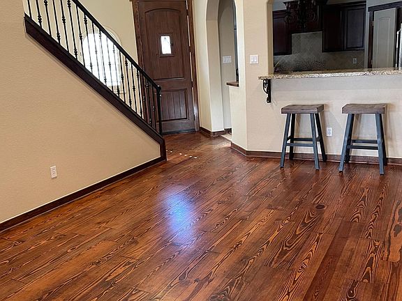 Breakfast bar off of kitchen with granite countertops, newly refinished travertine floors, a spacious walk-in pantry and stainless steel JennAir appliances.