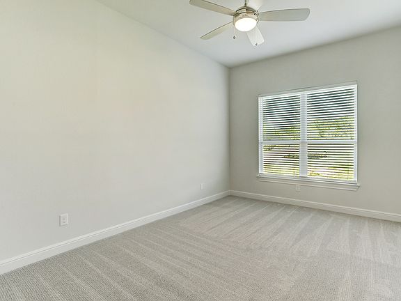 Secondary bedroom with large windows to create a light and airy space.