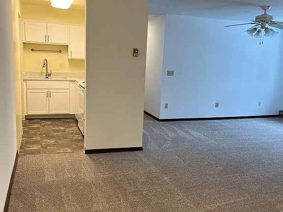 view from dining area into kitchen and living room.