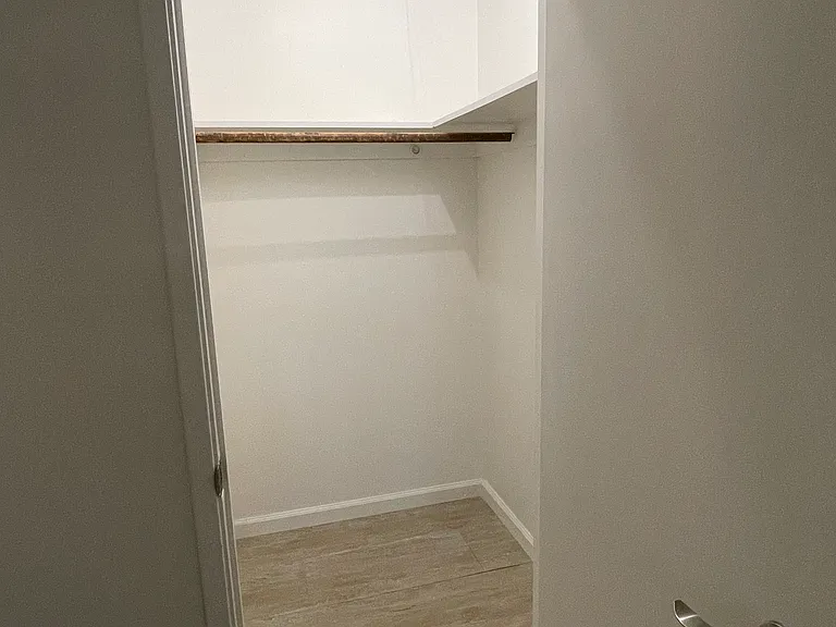 Walk-in closet in small bedroom