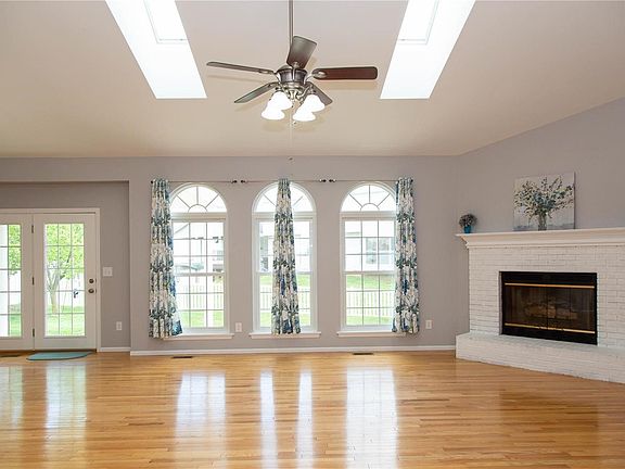 Vaulted ceilings range from the great room into the kitchen area. That is a gas fireplace.