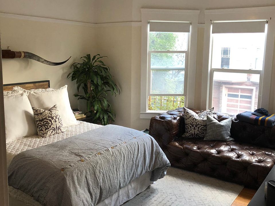 Bedroom with large closet and bay windows.