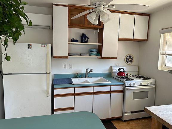 Full size kitchen with all dishes appliances and cooking utensils provided. Eating area/counter