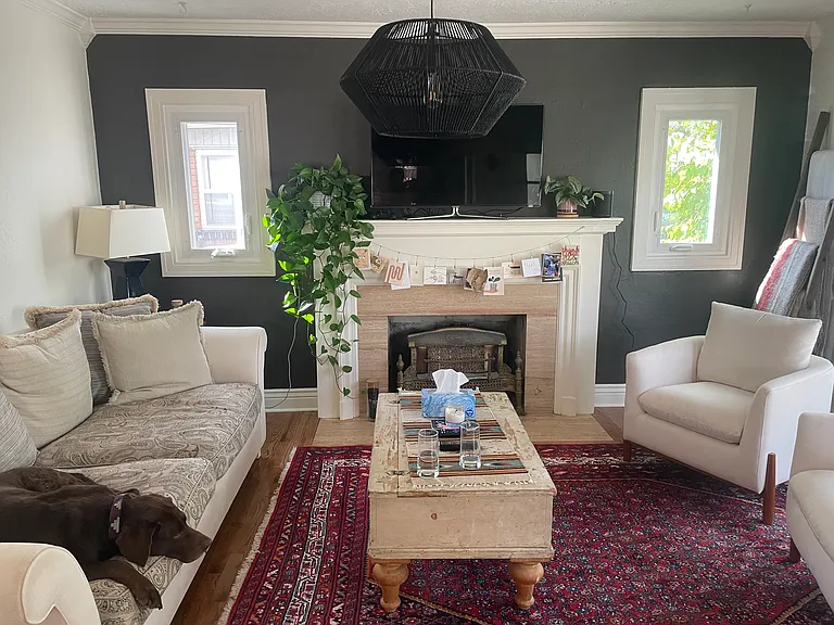 Living room pre-updated fireplace; has since been replaced with gas and is lovely in the colder months. Dog not included :)