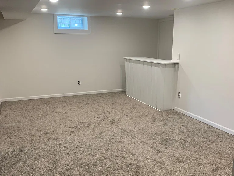 Newly finished basement with fresh carpet, paint