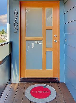 Front door has modern glass and is natural fir.