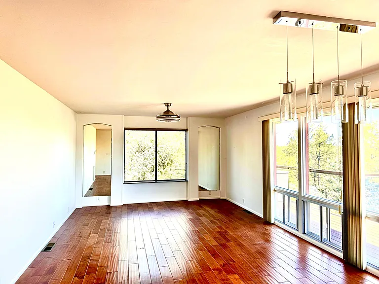 Living room and dining room. Filled with windows bringing the forest into the home and filling it with natural light.