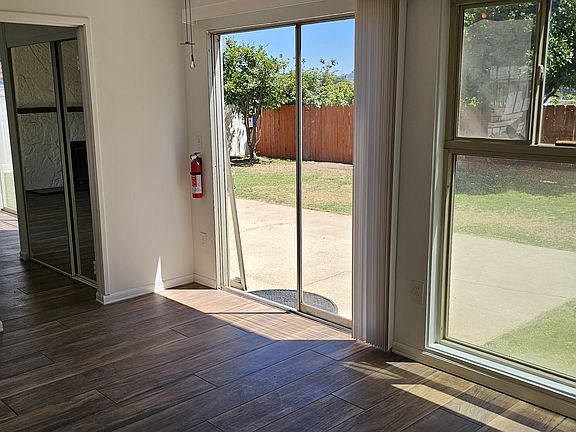 View from dining room to back yard. Mirrored pantry doors.