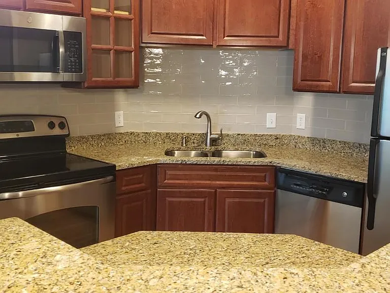 An even closer look into the kitchen and over the coutertop shows the additional working space on the drop down ledge